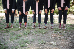 Triunfo Creek Vineyards navy groomsmen suits with blush ties and funny socks