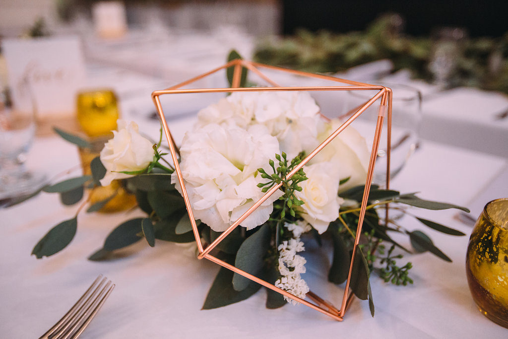 copper geometric flower vases, white flower centerpiece with greenery