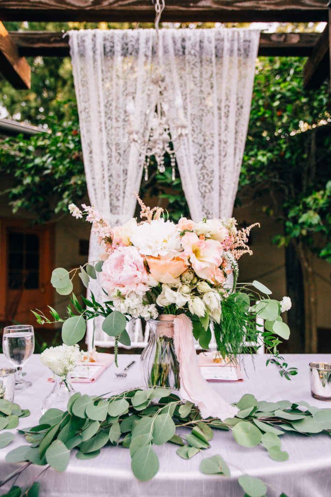 Rancho Buena Vista Adobe wedding reception sweetheart table, chandelier