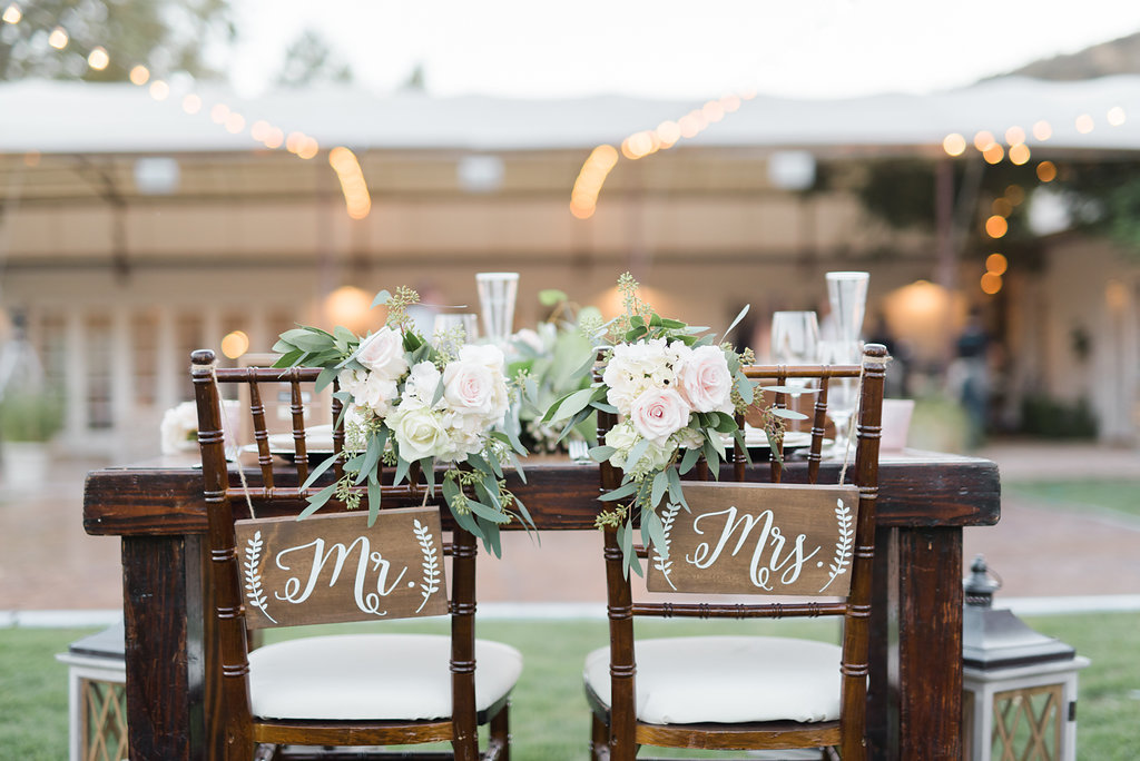 Triunfo creek vineyard wedding reception, sweetheart table, wood mr. and mrs. signs, white calligraphy