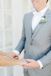 wedding first look, grey groomsmen suit, white spray rose boutonniere