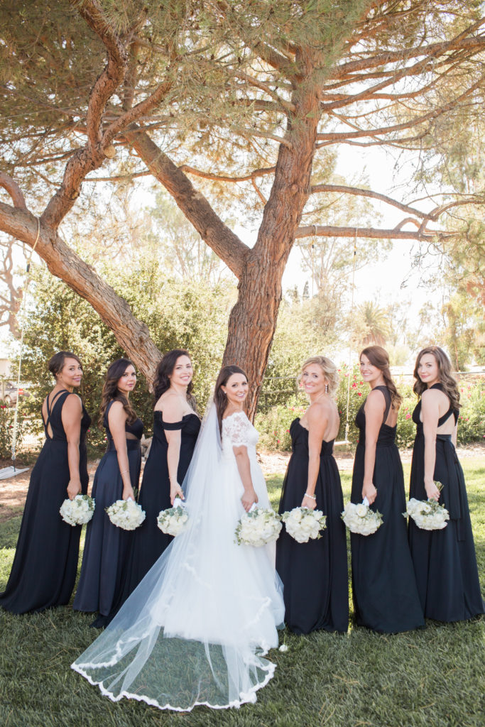 wedding at Sogno del Fiore winery in Santa Ynez, bridal party photo with mismatched black bridesmaid dresses and white flower bouquets