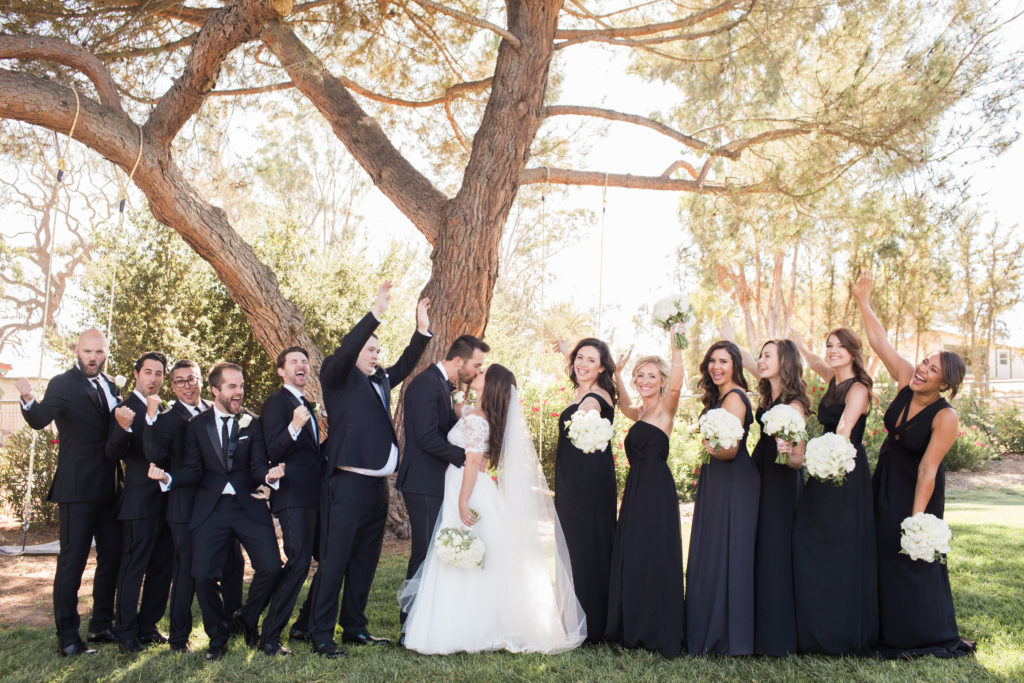 wedding at Sogno del Fiore winery in Santa Ynez, wedding party photo with mismatched black bridesmaid dresses and white flower bouquets