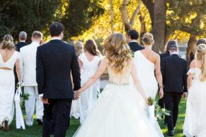 Royal Inspired Vineyard Wedding at Triunfo Creek Vineyards, wedding party photo with white bridesmaid dresses and black groomsmen suits