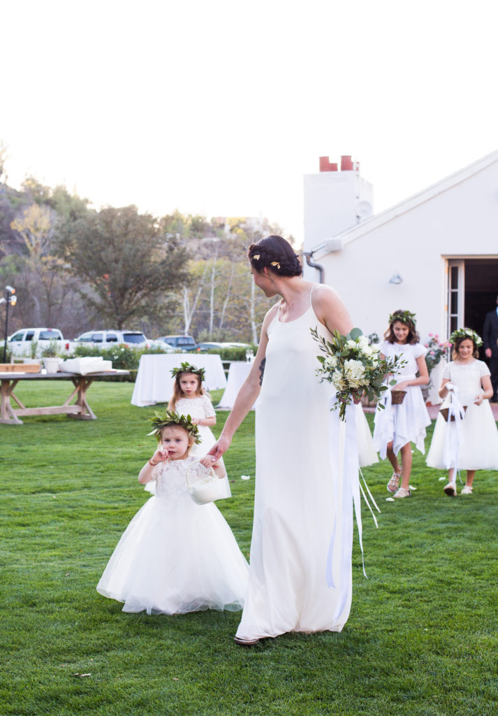 Royal Inspired Vineyard Wedding at Triunfo Creek Vineyards, flower girls with white dresses and greenery floral crowns
