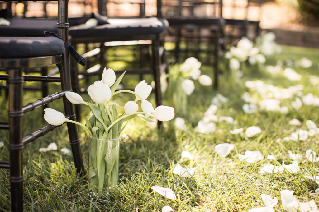 Sogno del fiore wedding ceremony in Santa Ynez winery with black chivari chairs and white flowers