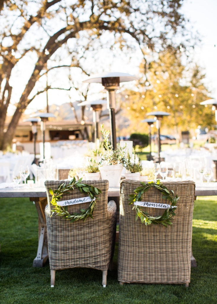 Royal Inspired Vineyard Wedding at Triunfo Creek Vineyards, greenery wreaths on Mr. Mrs. chairs, Madame and Monsieur wedding chairs