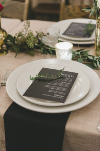 Ace Hotel wedding in Palm Springs wedding reception tablescape with greenery garlands and black and white menus