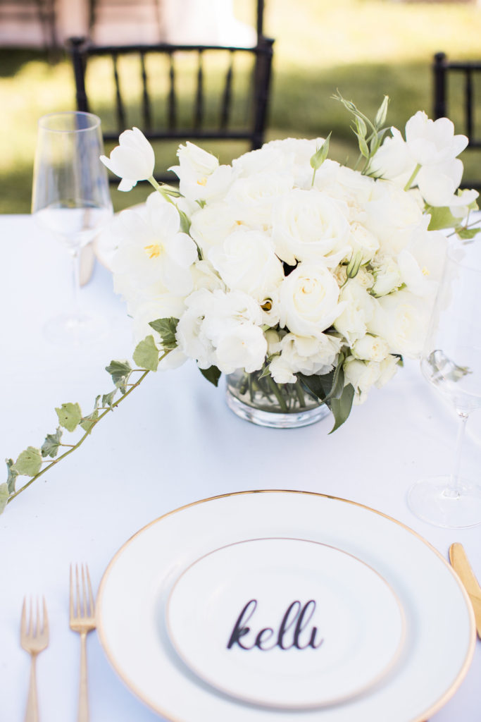 Sogno del fiore wedding reception in Santa Ynez winery, long tables with white tablecloths and black chivari chairs and all white flower centerpieces