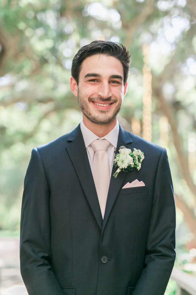 Calamigos Ranch wedding, black suit with pale blush tie, groom, white flower boutinierre