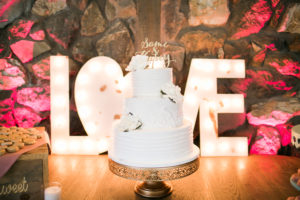 Calamigos Ranch Wedding Redwood Room reception cake with gold sign and love letters