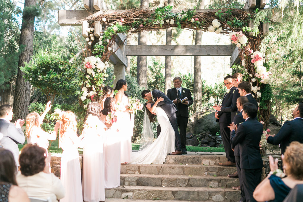 Calamigos Ranch wedding ceremony, bride and groom first kiss dip