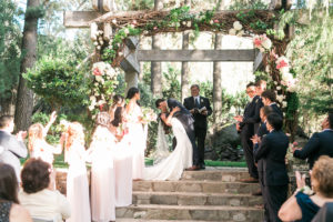 Calamigos Ranch wedding ceremony, bride and groom first kiss dip