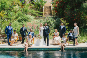 travel themed wedding at Mountain Mermaid, wedding party photo by pool