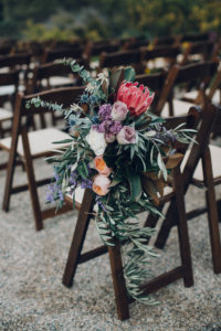 A desert wedding in Ojai at Red Tail Ranch, simple ceremony with king protea aisle flowers