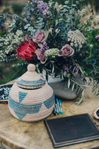 A desert wedding in Ojai at Red Tail Ranch, welcome table with woven card basket