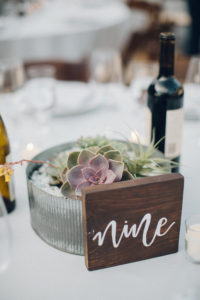 A desert wedding in Ojai at Red Tail Ranch, vintage bride and groom, succulent centerpiece with wooden table number