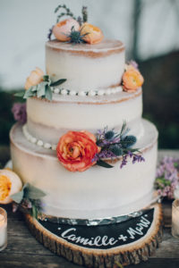 A desert wedding in Ojai at Red Tail Ranch, wedding cake with orange flowers