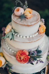 A desert wedding in Ojai at Red Tail Ranch, wedding cake with orange flowers