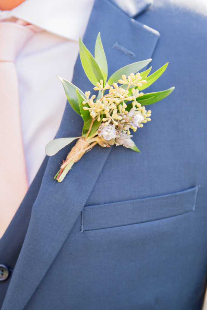 Elegant fall wedding at Triunfo Creek Vineyards, green and white groom boutonniere