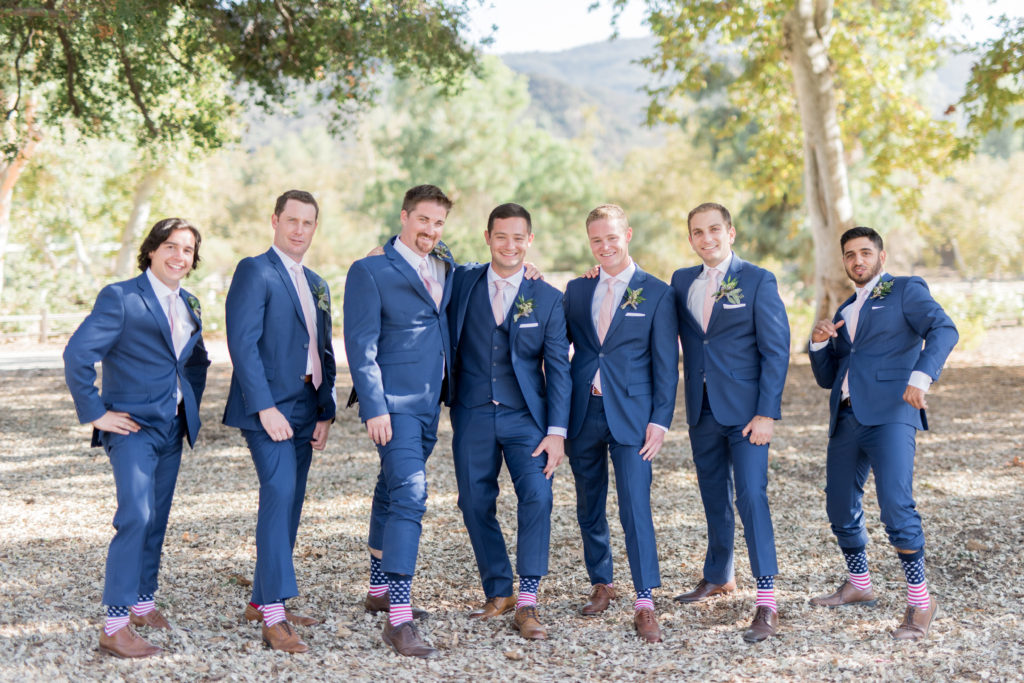 Elegant fall wedding at Triunfo Creek Vineyards, groom and groomsmen in blue suits, groomsmen american flag socks