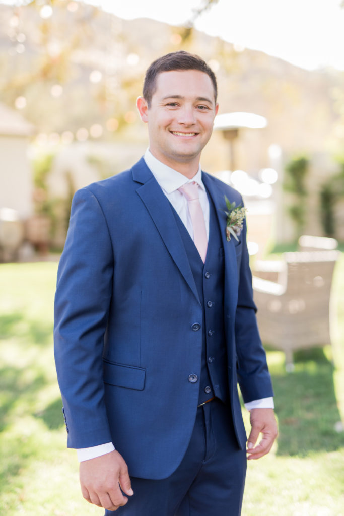 Elegant fall wedding at Triunfo Creek Vineyards, groom in blue suit and pink tie