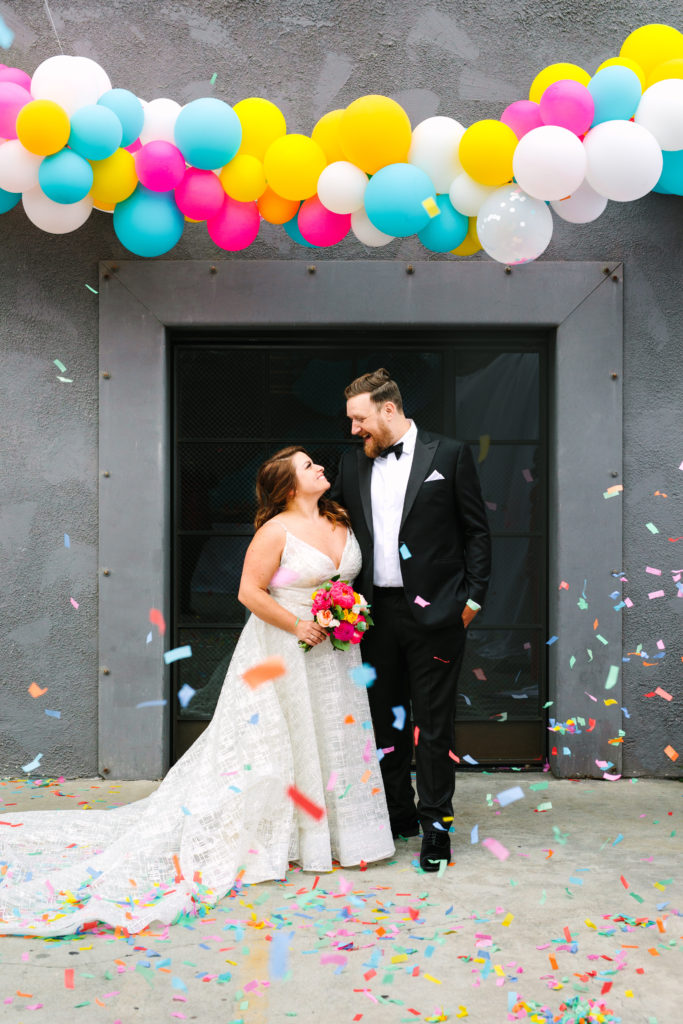 A colorful wedding at Unique Space LA, bride and groom portrait shot with confetti