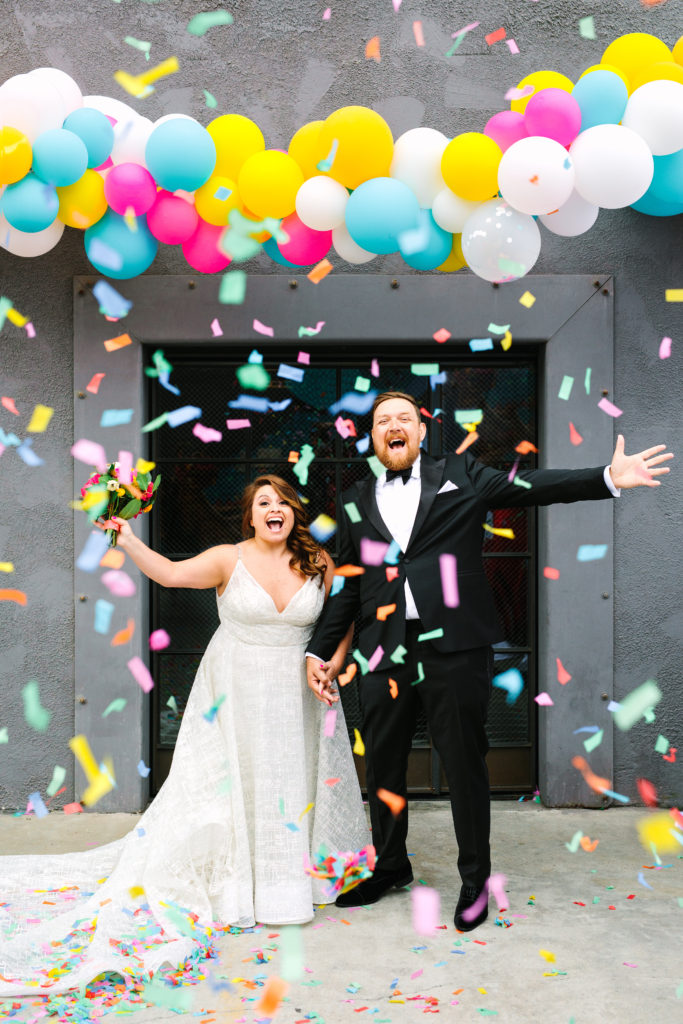 A colorful wedding at Unique Space LA, bride and groom portrait shot with confetti