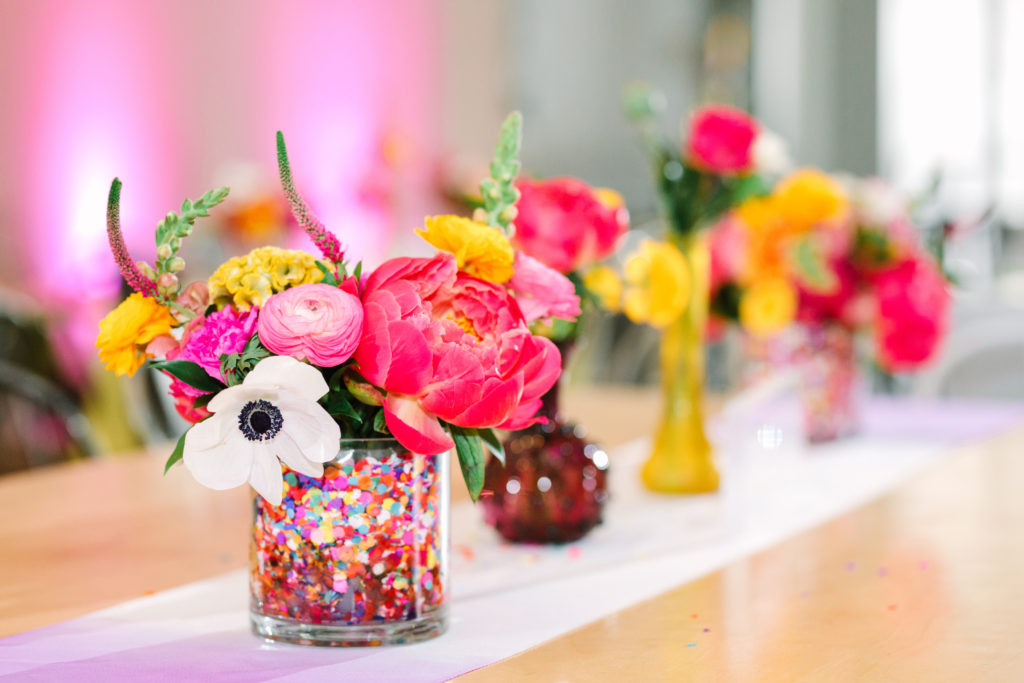 A colorful wedding at Unique Space LA, colorful mismatched confetti filled floral centerpieces