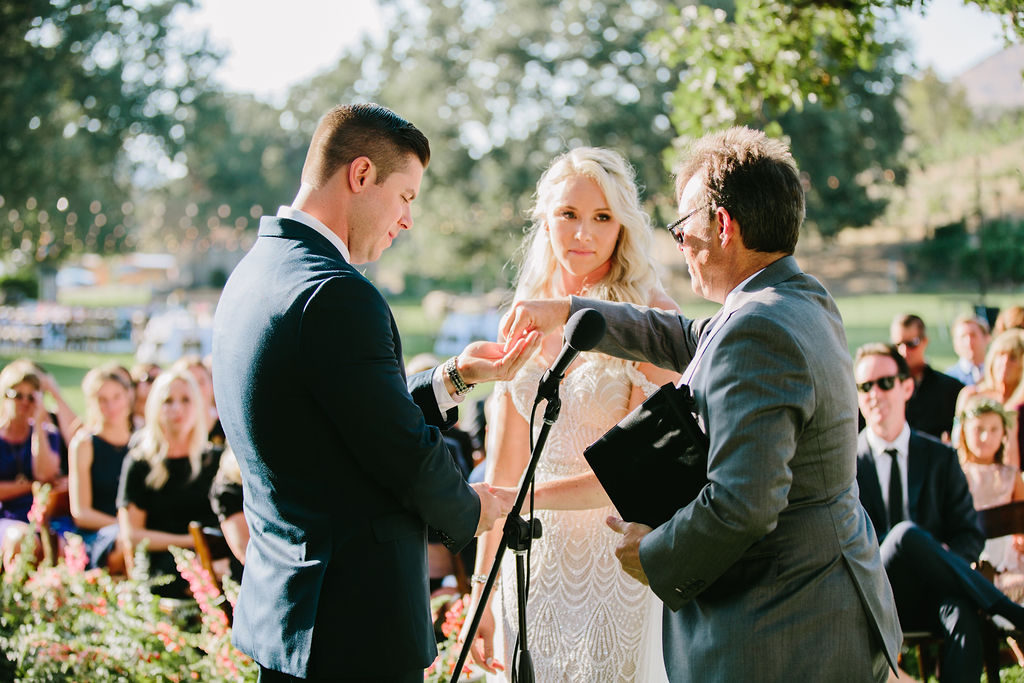 exchanging of rings during wedding ceremony at Triunfo Creek Vineyards
