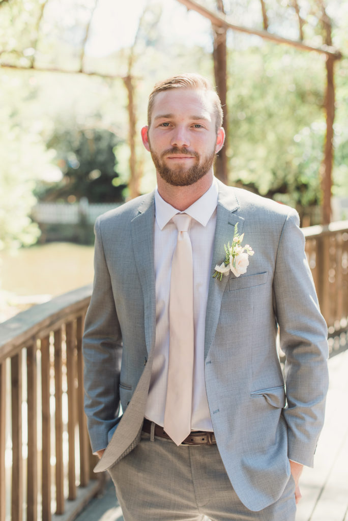 An emotional calamigos ranch wedding, groom in grey suit with pale pink tie