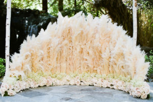 east coast meets west coast wedding ceremony at Calamigos Ranch with pampas grass aisle flowers