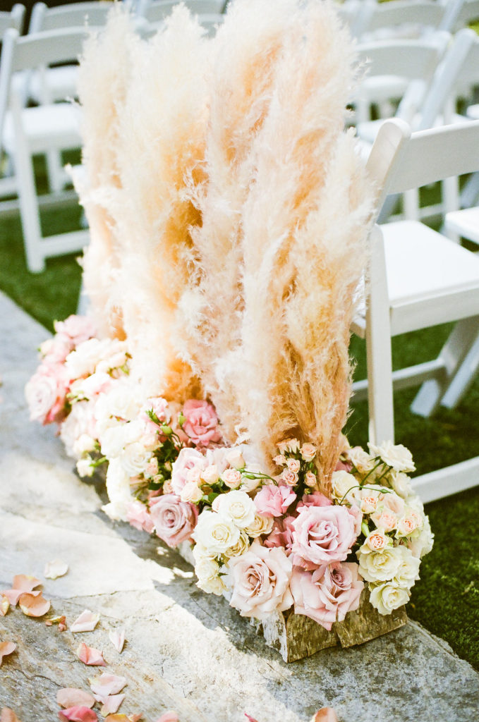 east coast meets west coast wedding ceremony at Calamigos Ranch with pampas grass aisle flowers