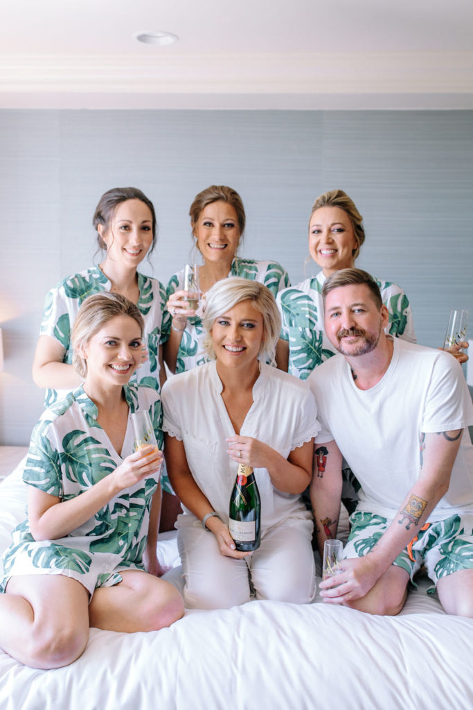A glam and California infused wedding at Viceroy Santa Monica, bride with wedding party getting ready in monstera leaf pajamas