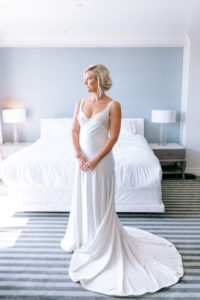 A glam and California infused wedding at Viceroy Santa Monica, bride getting ready wearing silk slip wedding dress with updo