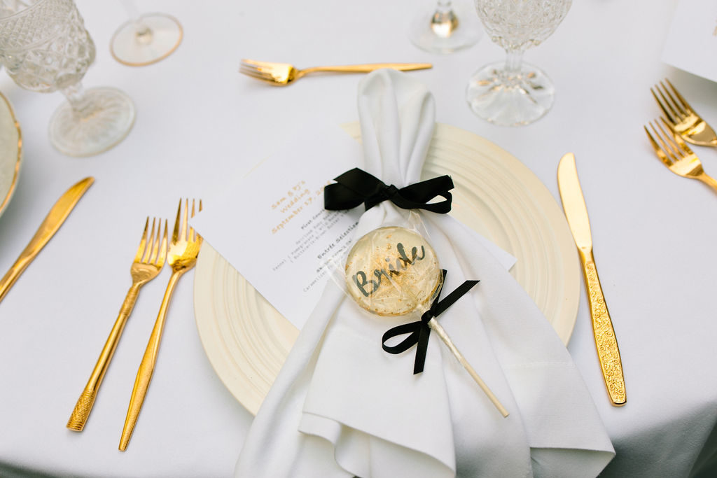 A glam and California infused wedding reception at Viceroy Santa Monica, personalized guest favor lollipop as place card