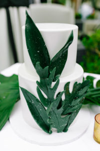 A glam and California infused wedding reception at Viceroy Santa Monica, dessert table with monstera leaf wedding cake