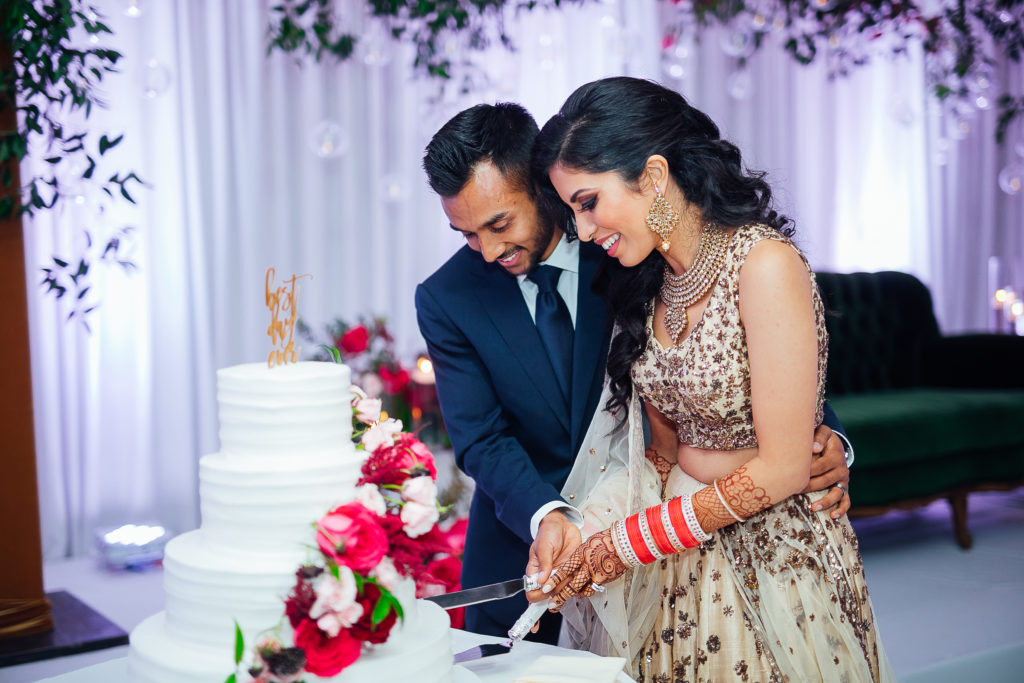 Stunning Indian wedding reception at the DoubleTree Hotel in San Pedro, bride and groom cut cake