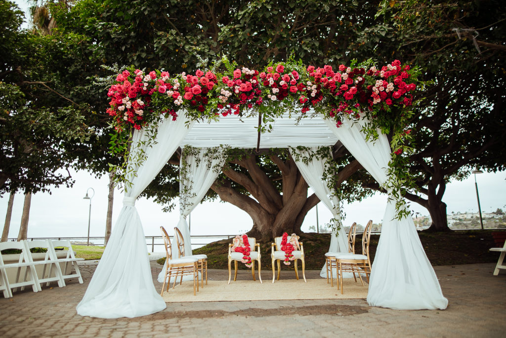 Stunning Indian Wedding in San Pedro, red and blush floral arch with draping