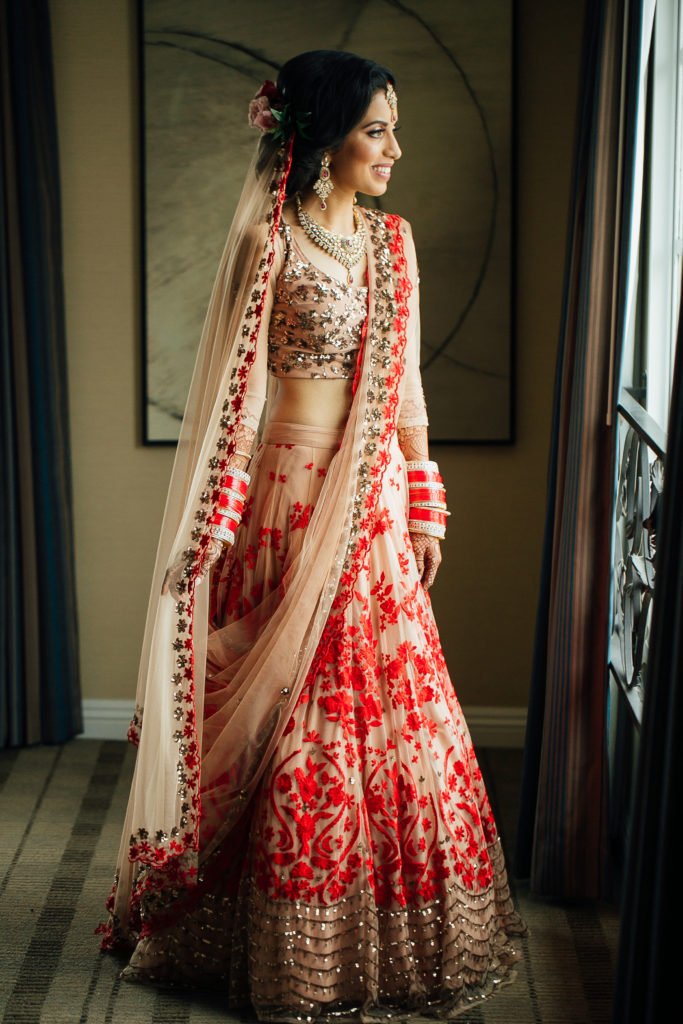 Stunning Indian Wedding in San Pedro, bride in gold and red wedding sari getting ready
