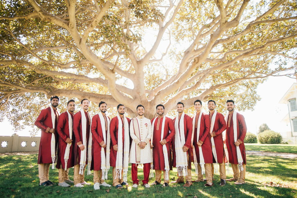Stunning Indian Wedding in San Pedro, groom and groomsmen in red and gold sherwanis