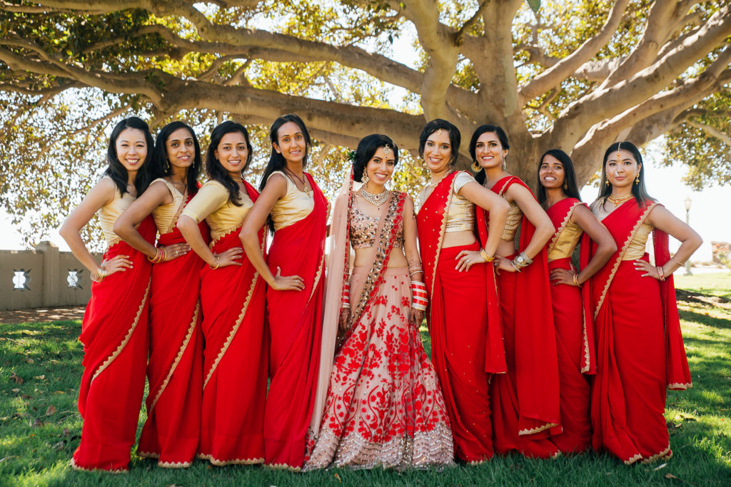 Stunning Indian Wedding in San Pedro, bride and bridesmaids in red and gold sarees