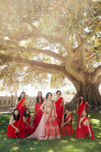 Stunning Indian Wedding in San Pedro, bride and bridesmaids in red and gold sarees