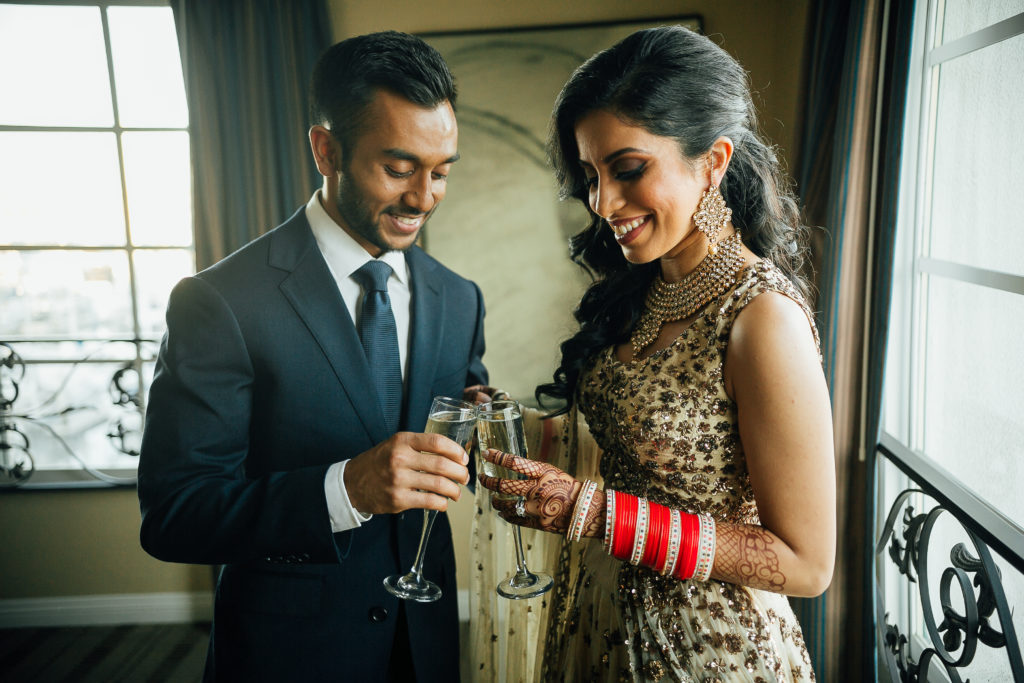 Stunning Indian wedding reception at the DoubleTree Hotel in San Pedro, bride and groom champagne toast