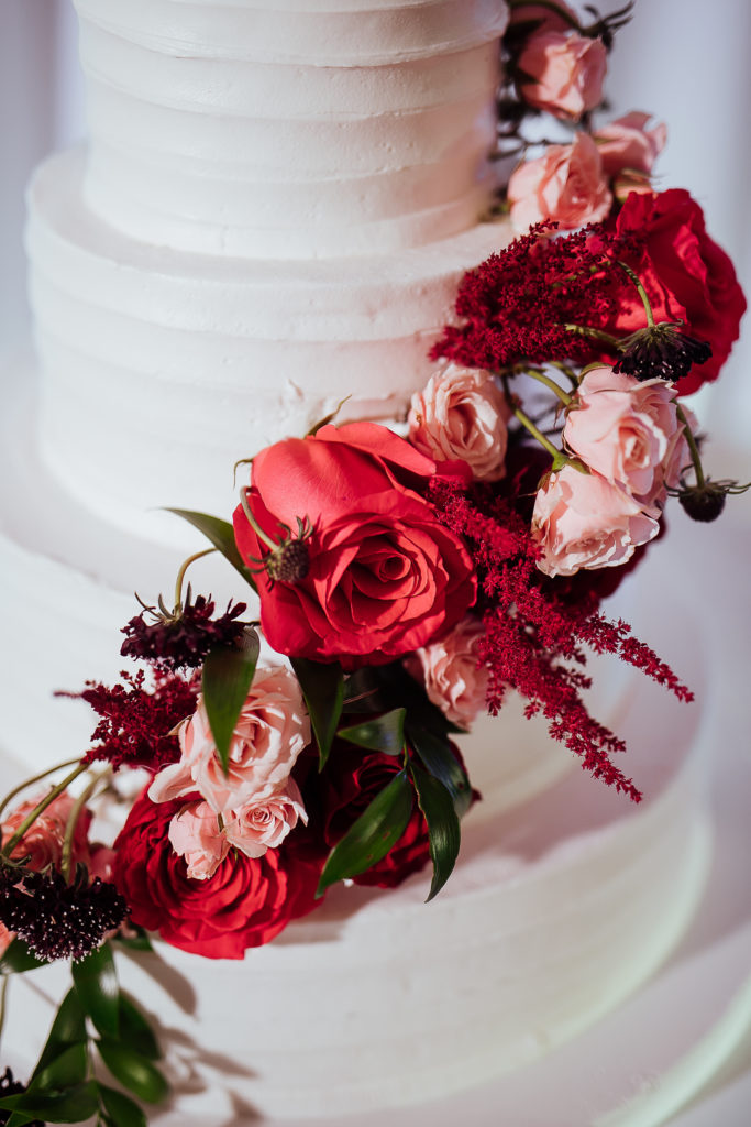 Stunning Indian wedding reception at the DoubleTree Hotel in San Pedro, white wedding cake with red and pink roses