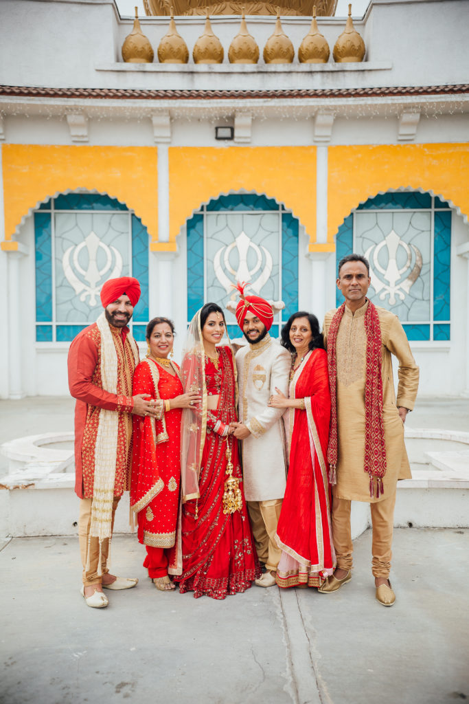 Stunning Indian Wedding in San Pedro, red bridal sari and groom in gold sherwani for sikh ceremony, bride and groom portrait