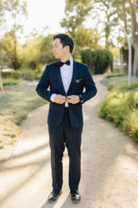 groom in classic black tuxedo at this contemporary wedding at the Natural History Museum in Los Angeles