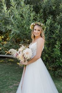 A chic rustic wedding at Calamigos Ranch, bride with wildflower bridal bouquet and wearing a flower crown