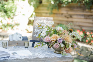 A chic rustic wedding at Calamigos Ranch, welcome table with vintage lace runner