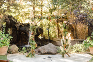 A chic rustic wedding ceremony at Calamigos Ranch, pampas grass floral arch